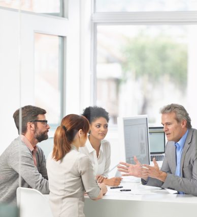 A group of businesspeople going over some plans together.